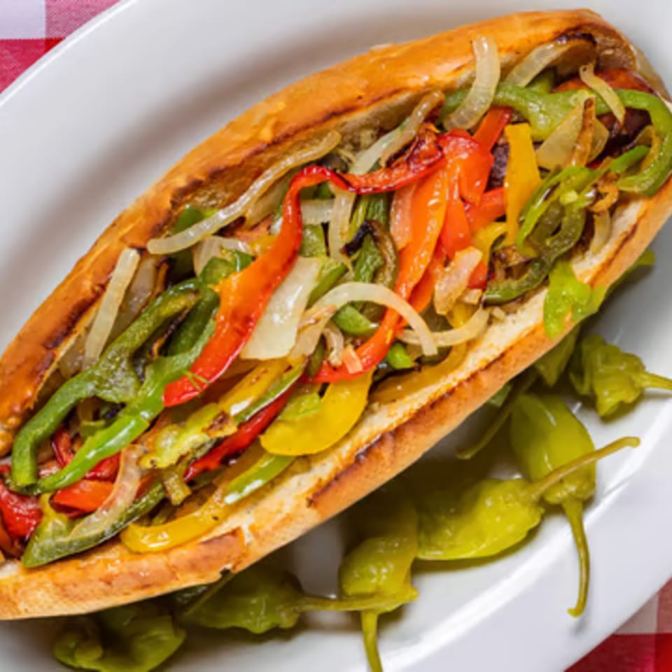 Enzo's Pizzeria's colorful sub sandwich with grilled peppers and onions, served with pickled peppers.